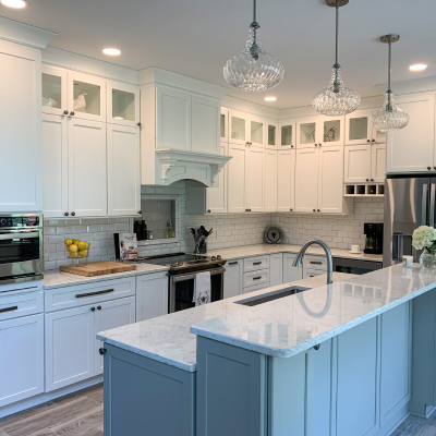 A kitchen remodel with white cupboards