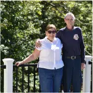 A couple standing by a railing