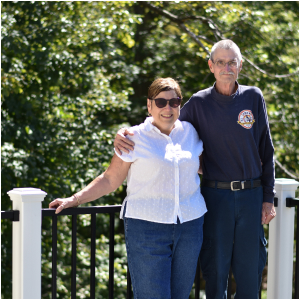 A couple standing by a railing