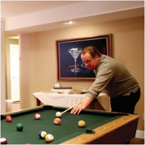 A man playing pool in a remodeled space