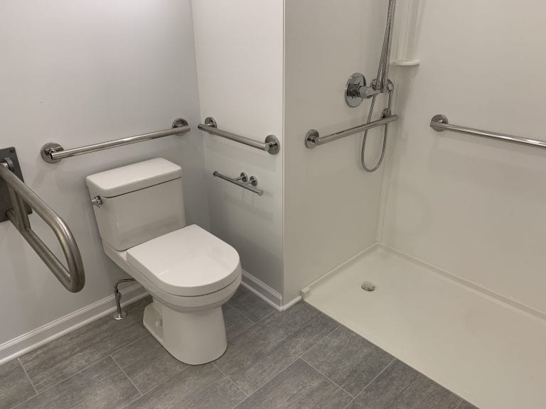  bathroom with accessibility handles for shower and toilet 