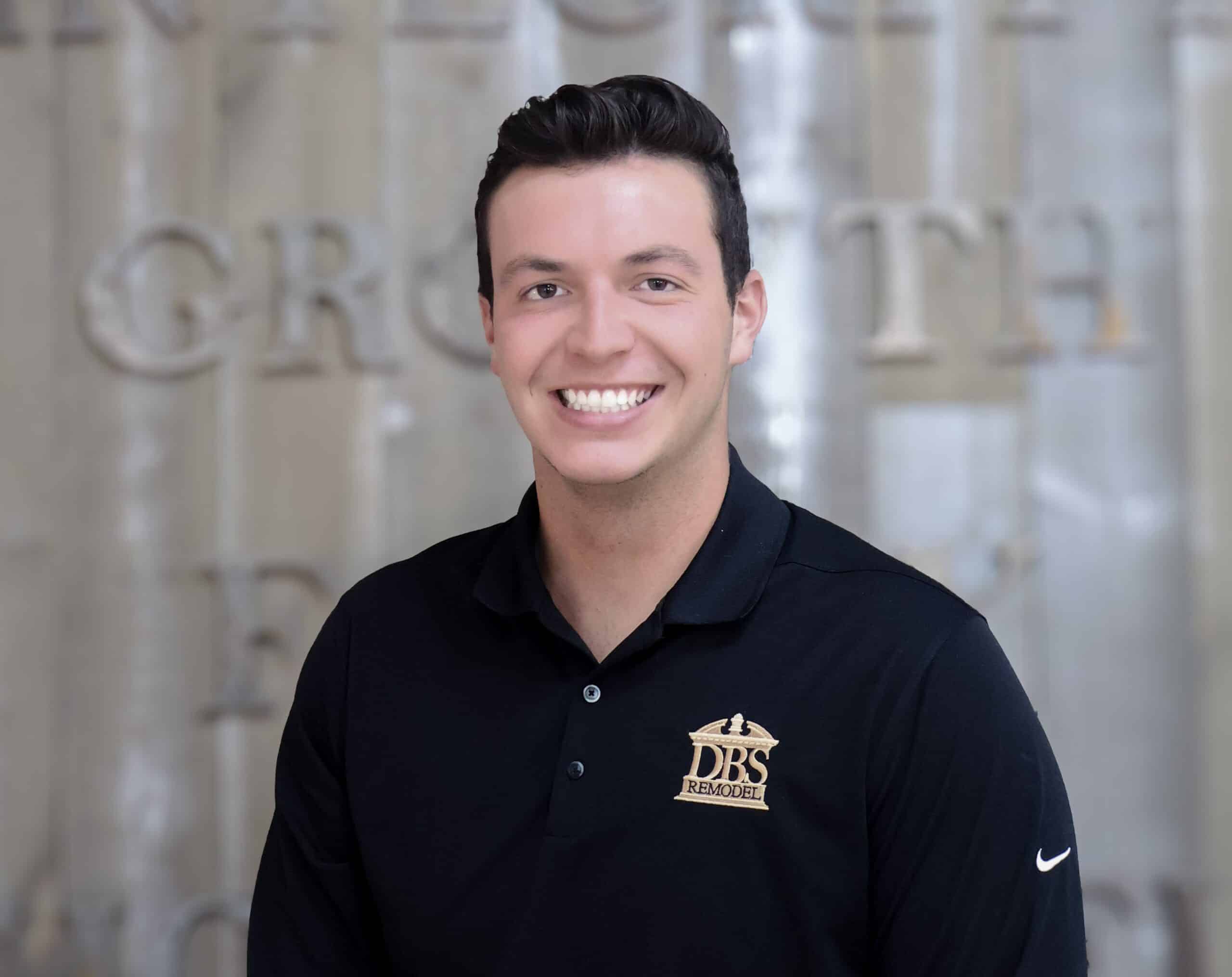 DBS Remodel team member portrait wearing company logo shirt inside showroom setting